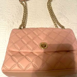 Never used light pink Kate spade purse with chained shoulder strap.